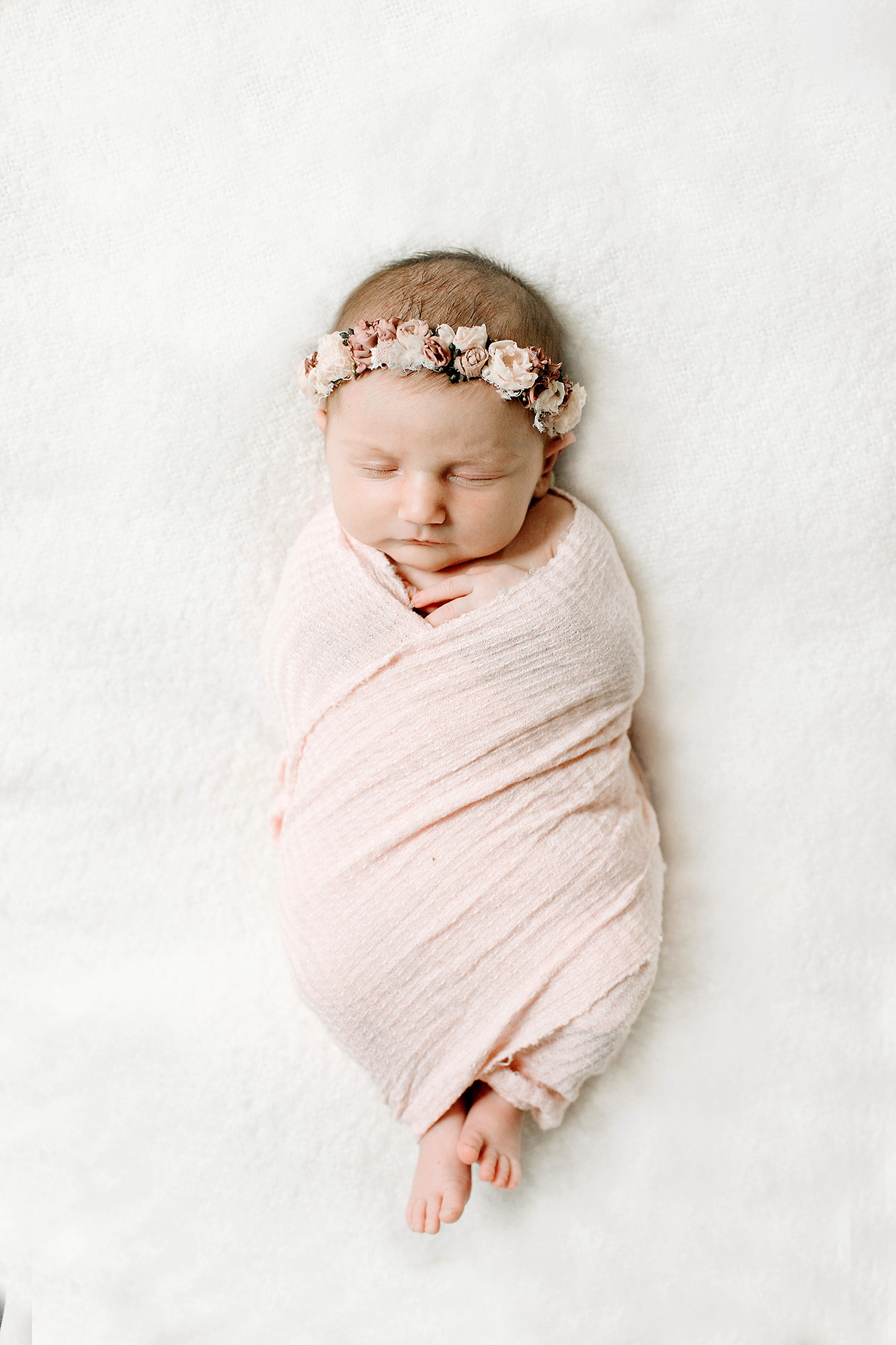 Newborn baby with floral headband