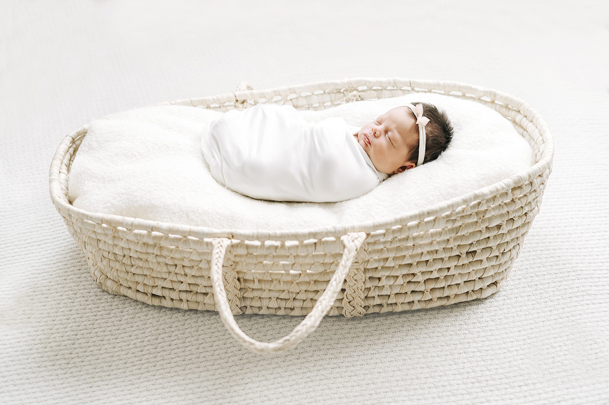 Newborn baby in a moses basket lifestyle session